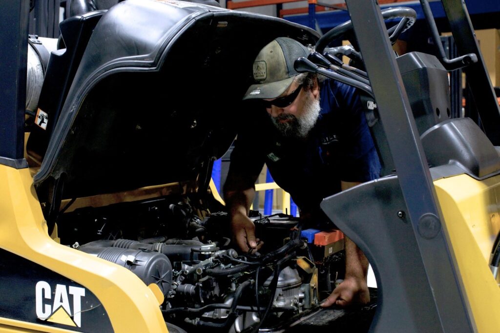 Forklift Maintenance Guide working on forklift