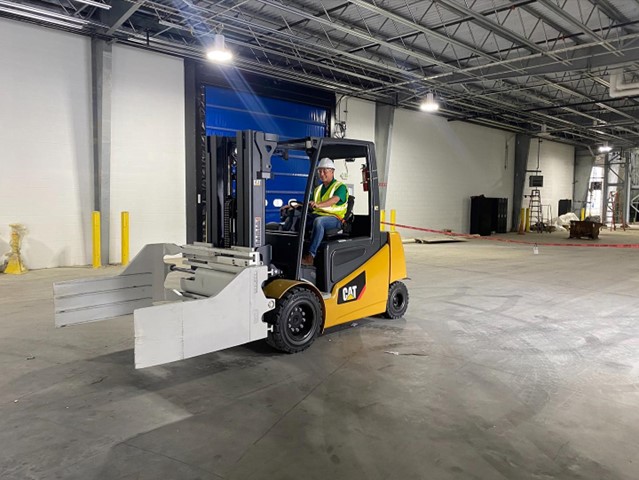 Man driving a forklift in a warehouse