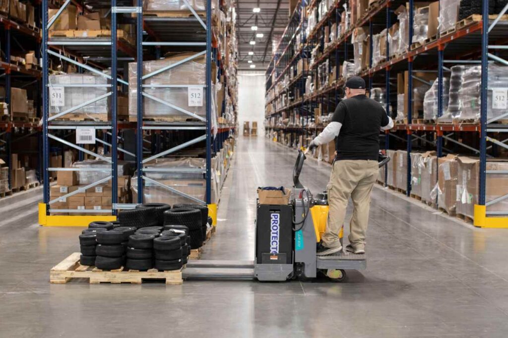 Man operating pallet jack in a warehouse