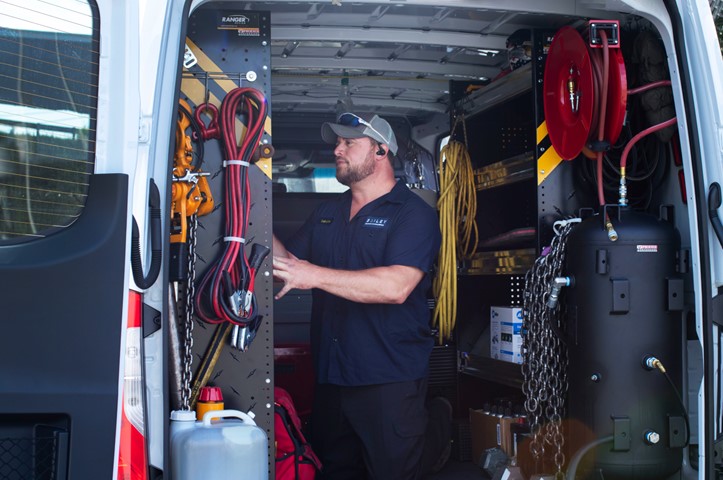 Technician working inside a service van
