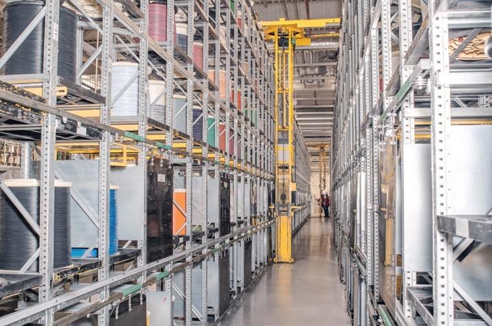 Automated storage retrieval system with tall warehouse racks