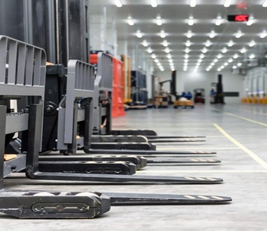 Forklifts Lined Up in a Warehouse Aisle