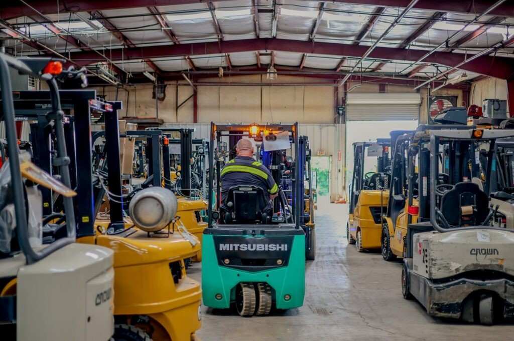 Forklifts operating inside a busy industrial warehouse