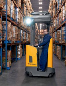 jungheinrich reach truck operating in high-density warehouse storage